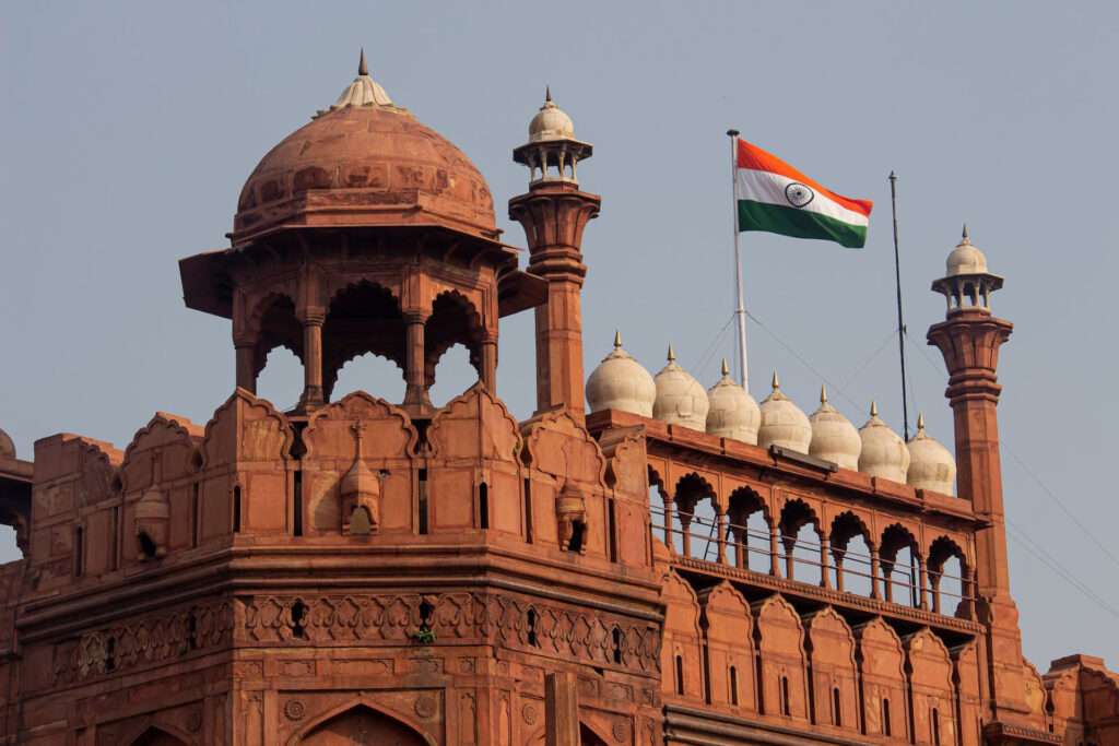 Under the golden embrace of daylight, the Red Fort stands majestically, revealing its timeless magnificence against the azure sky in a testament to India's rich historical legacy. Red fort has been one of the central attraction point for the tourist that book one day delhi city trip package by car.